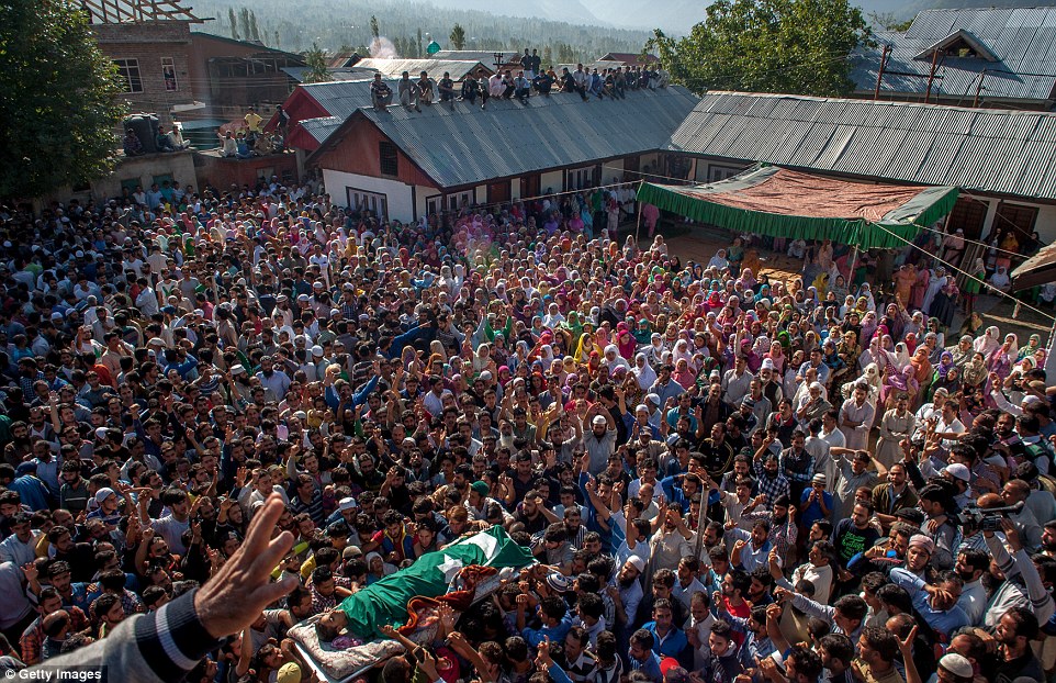 Kashmiri Muslim attend the funeral of a local militant commander killed in encounter with Indian forces. Kashmiri Muslim attend the funeral of a local militant commander killed in encounter with Indian forces.